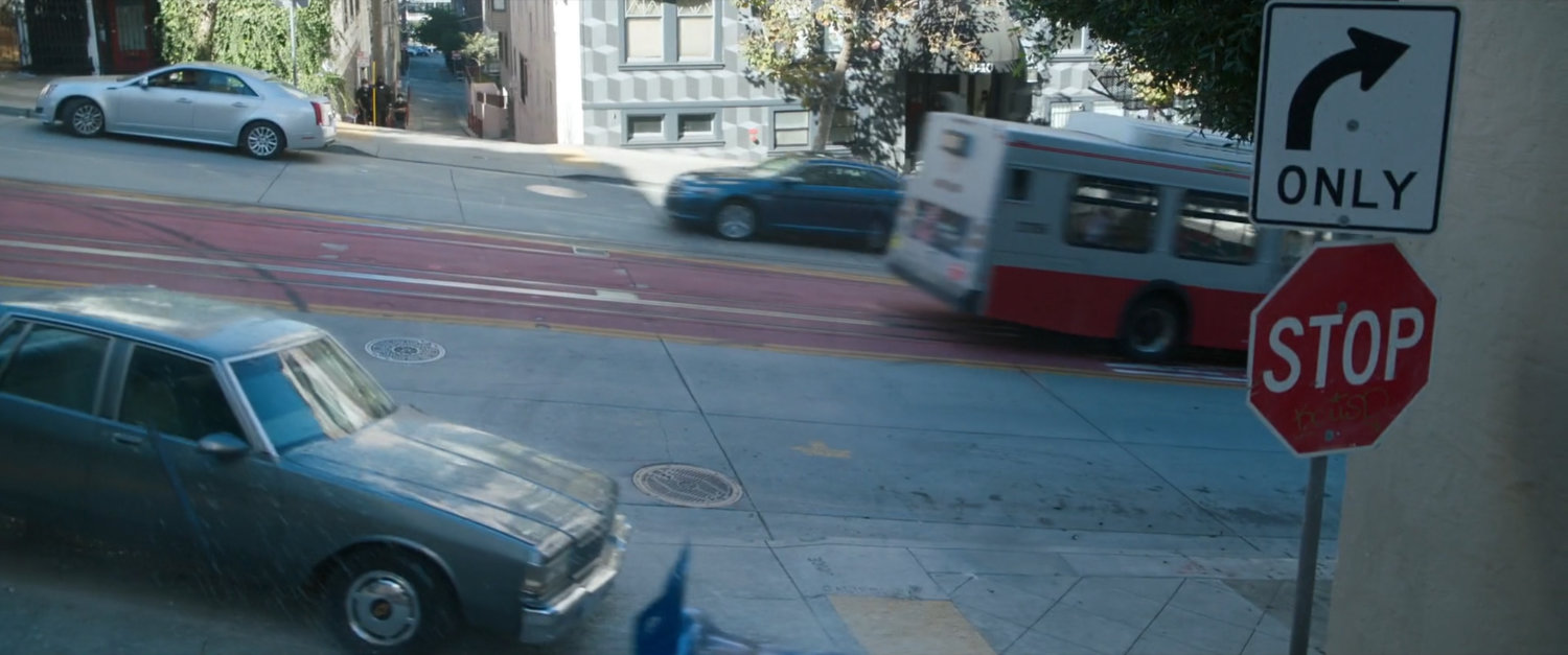 Exterior of San Francisco metro bus racing down street.