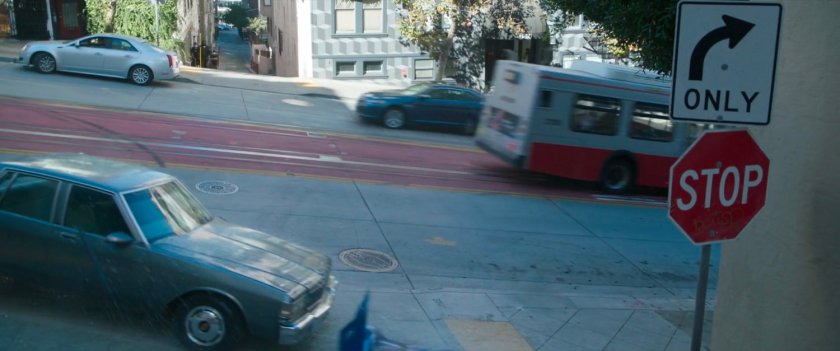 Exterior of San Francisco metro bus racing down street.