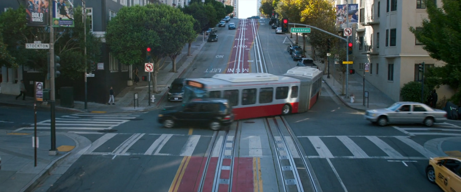 San Francisco metro bus making a tight turn in an intersection.