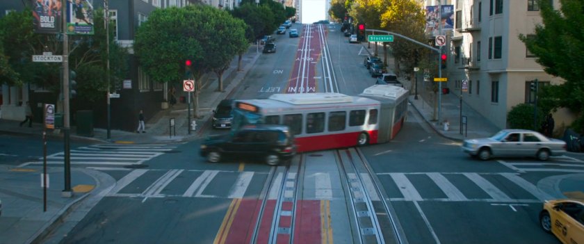 San Francisco metro bus making a tight turn in an intersection. 
