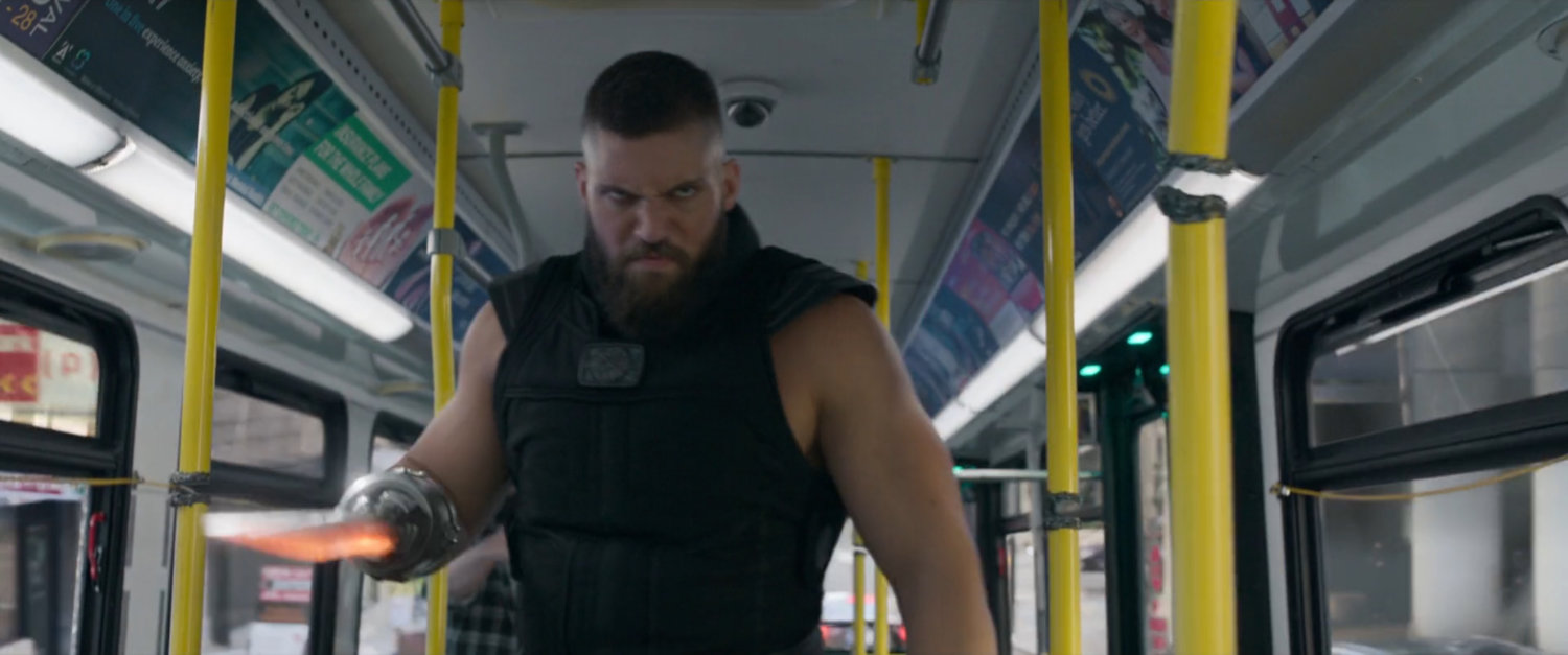 RazorFist comes menacingly toward camera on a San Francisco metro bus.