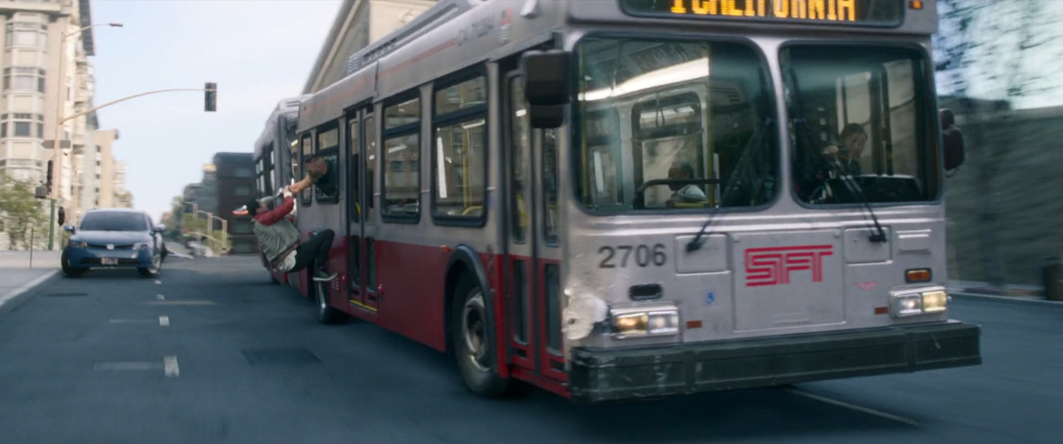 Shaun hangs on the outside of a San Francisco metro bus.