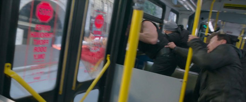A crowd inside a San Francisco metro bus is jostled.