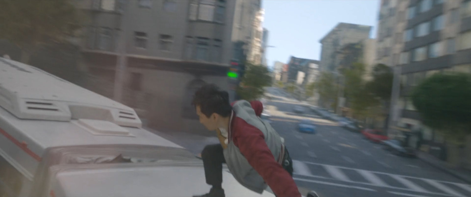Shaun stands on the top of a San Francisco metro bus.