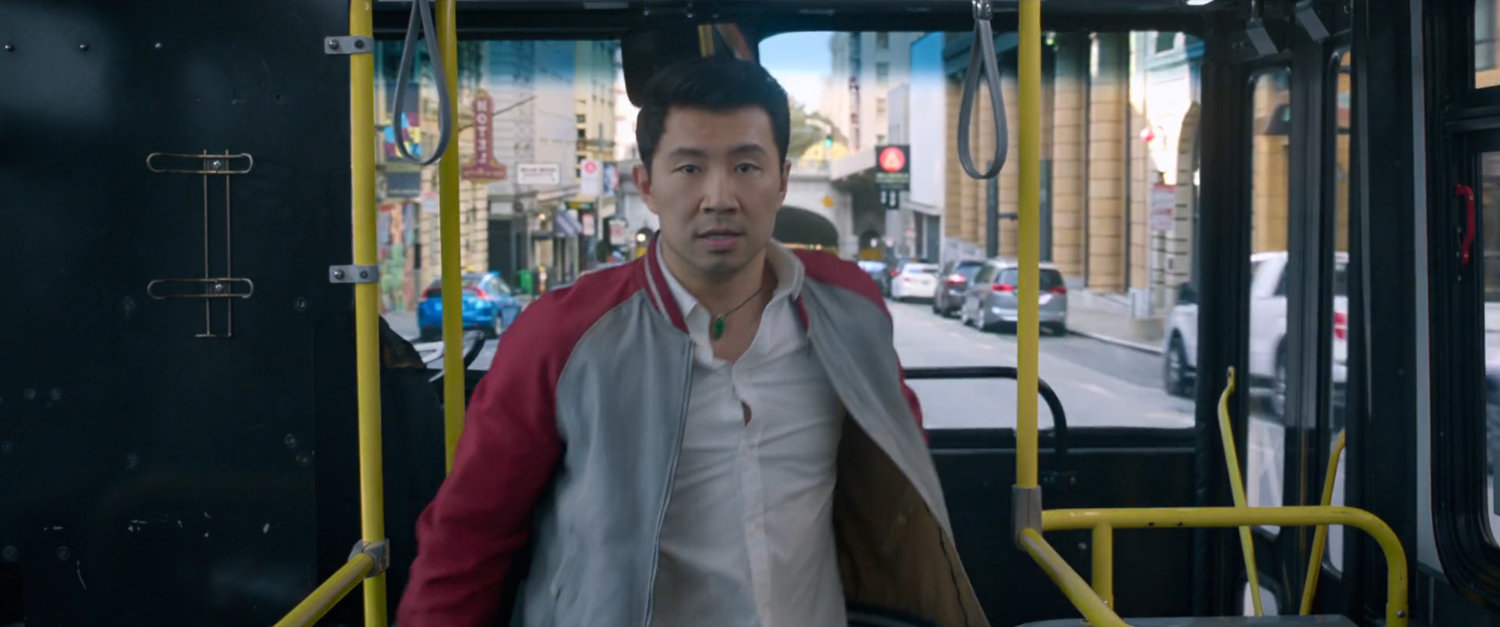 Shaun stands at the entrance of a San Francisco metro bus.