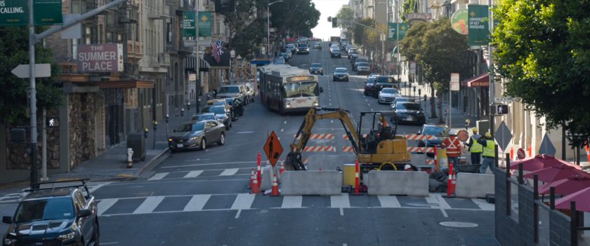 A San Francisco metro bus swerving towards street construction.