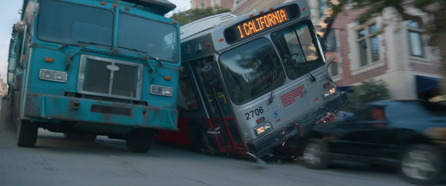 A San Francisco garbage truck and city bus run over parked cars speeding down street.