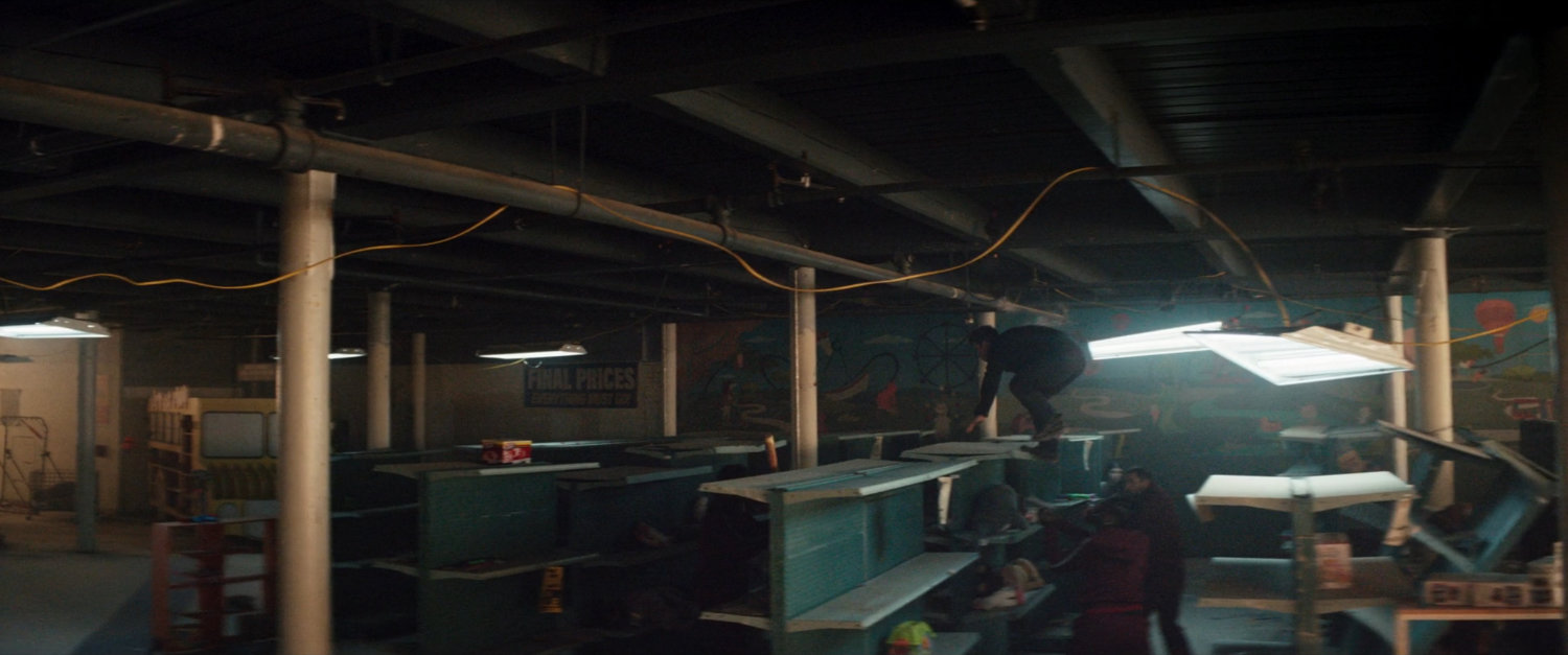 Clint evading the tracksuit mafia, running through an abandoned toy store.