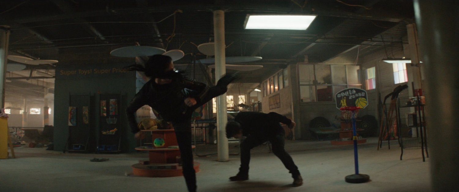 Clint fights Echo in an abandoned toy store.