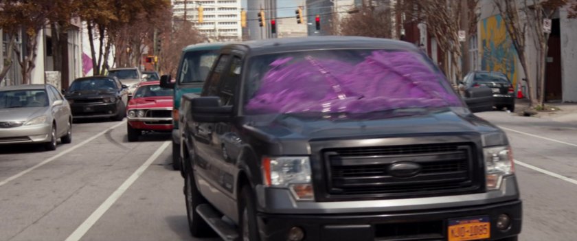 A pickup truck with purple goop on the windows.