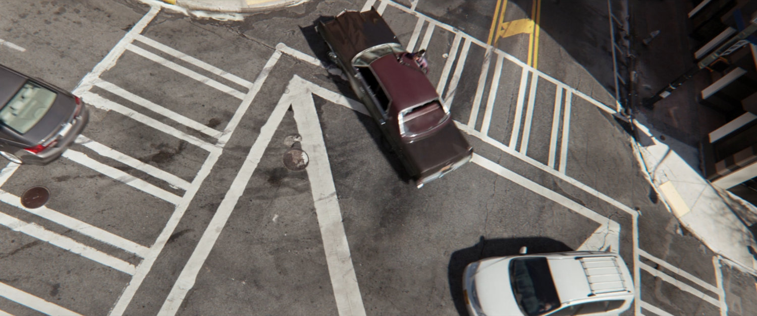 Aerial view of car skidding through intersection.