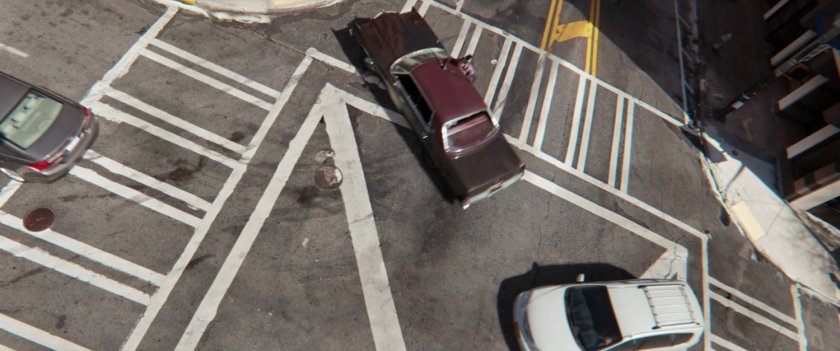 Aerial view of car skidding through intersection.