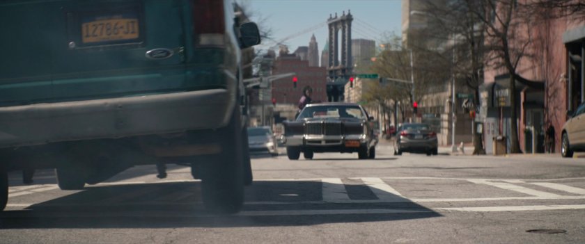 Car speeding through New York street.
