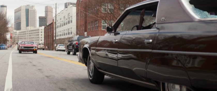 Two cars driving head to head.