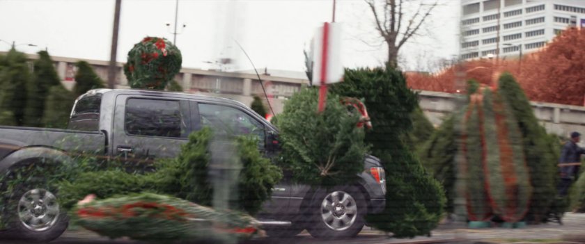 Pickup truck crashes through trees in Christmas Tree lot.