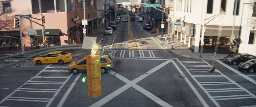 High angle shot of cars approaching intersection.