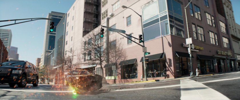 Traffic light crashing into middle of intersection.