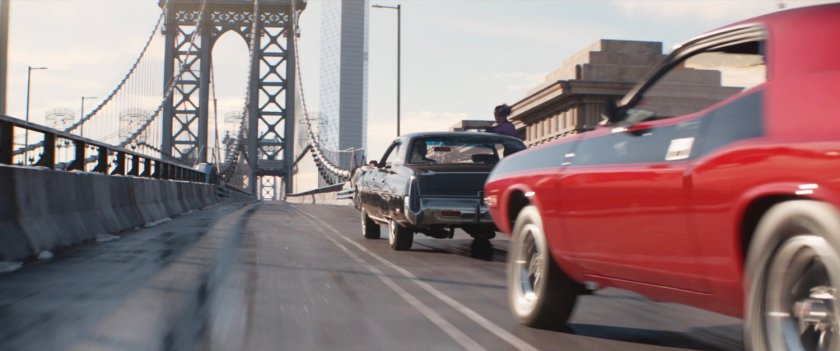 Two cars racing across Manhattan Bridge.