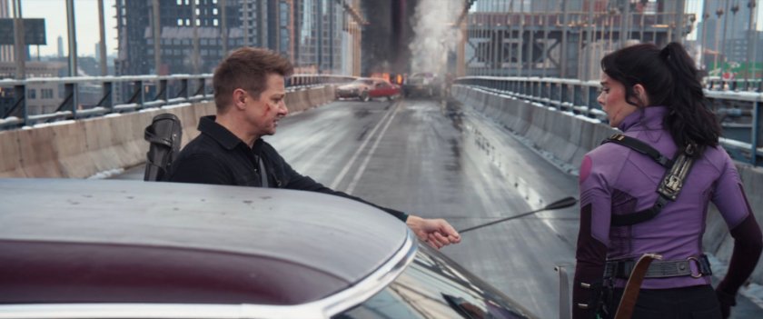 Clint hands Kate an arrow on the Manhattan Bridge.