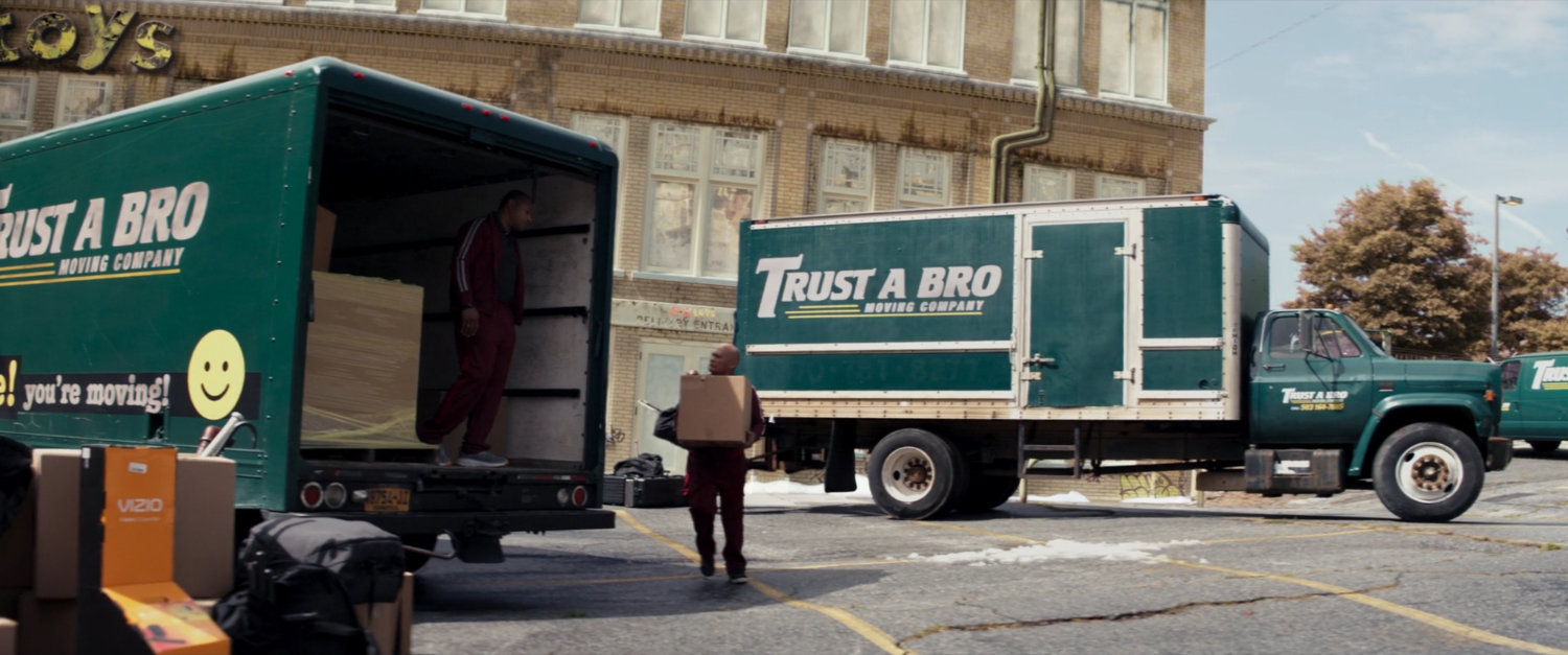 Trust-A-Bro vans in an abandoned toy store parking lot.