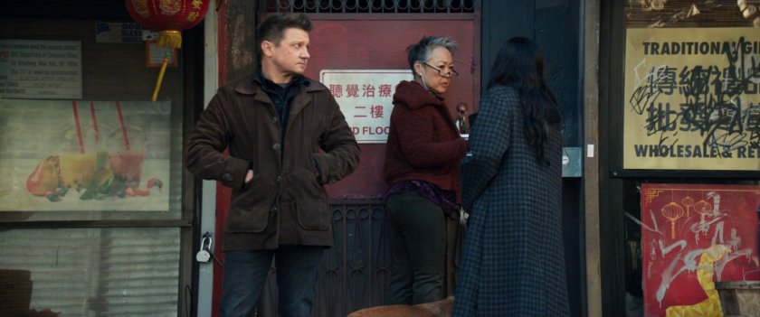 Clint, Kate and a shop owner in front of Chinatown store.
