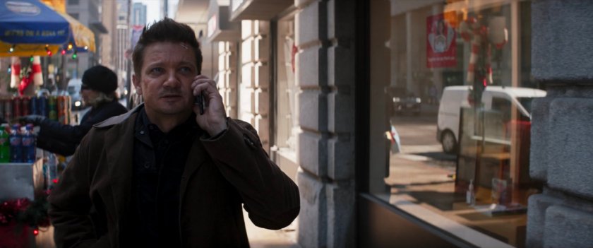 Clint talking on phone while walking on a New York sidewalk.