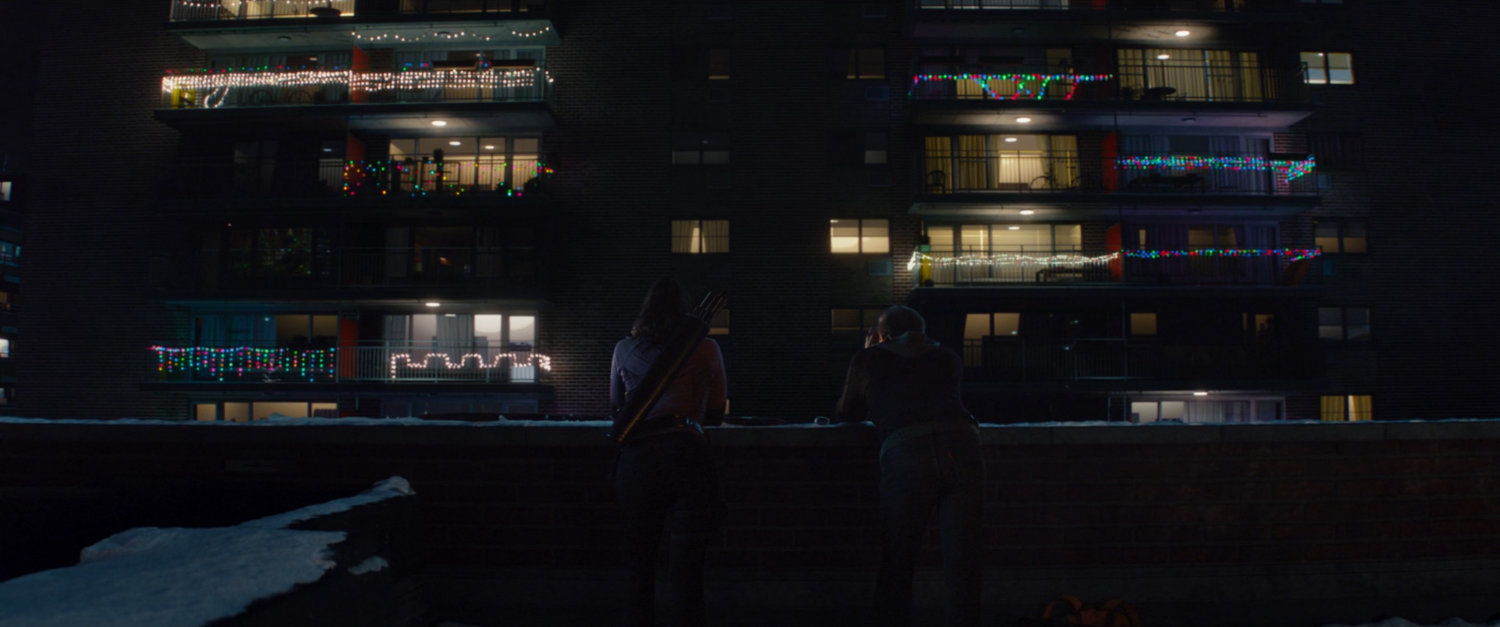 Kate and Clint on a rooftop across from Maya's apartment.