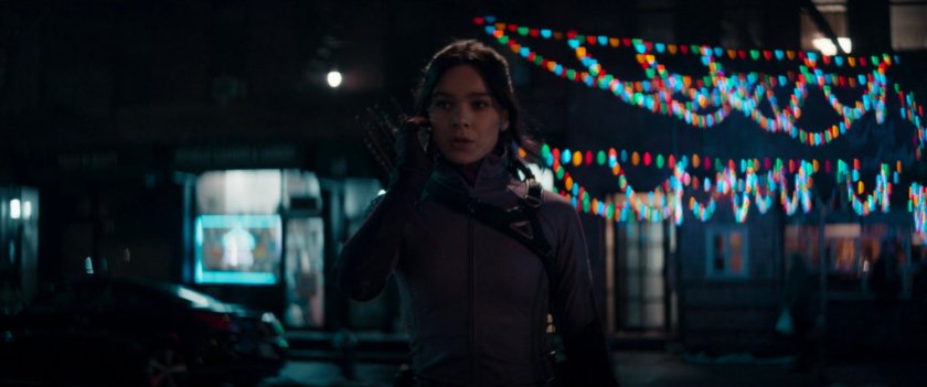 Kate in front of Maya's apartment.