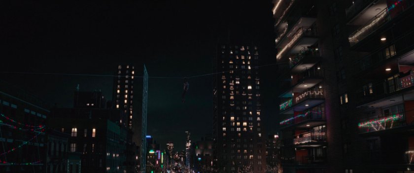 Kate suspended on wire between buildings.