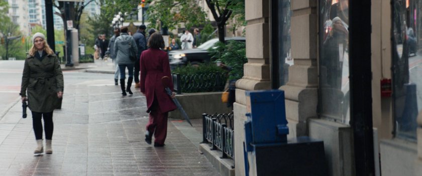 Eleanor walking on sidewalk outside of Kingpin's hotel.