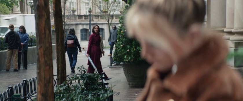 Yelena watching Eleanor walking on sidewalk outside of Kingpin's hotel.