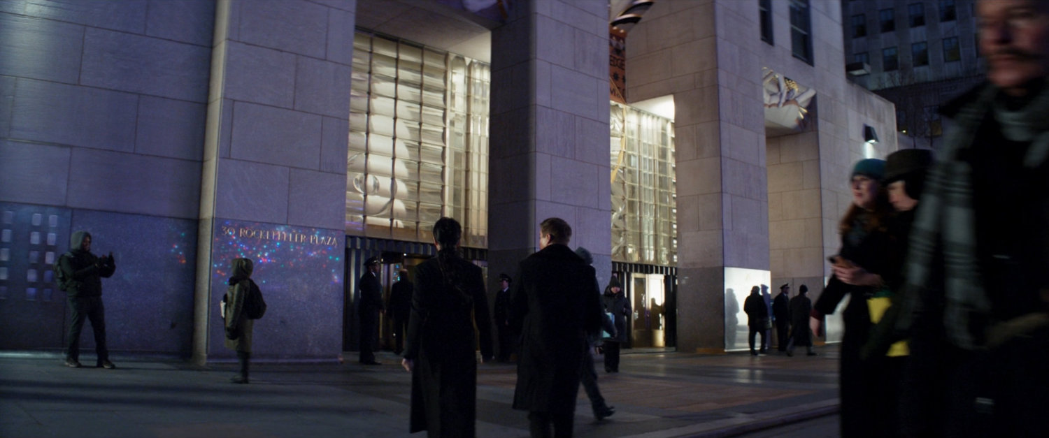 Kate and Clint enter Rockefeller Center.