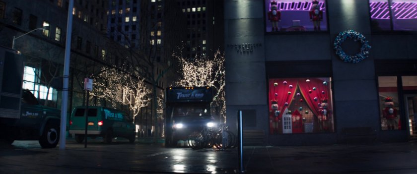 Trust-A-Bro van on sidewalk outside FAO Schwarz toy store.