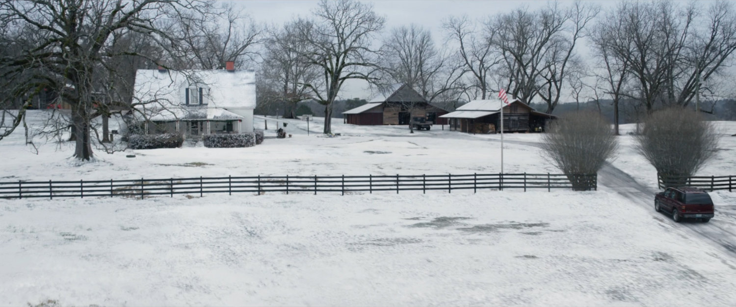 A high angle view of a snowy Barton farm.