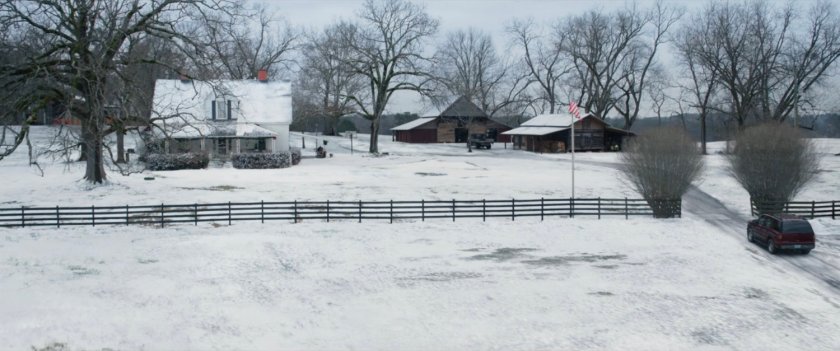 A high angle view of a snowy Barton farm.