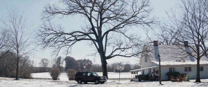 An SUV pulls up in front of a snowy Barton farm.