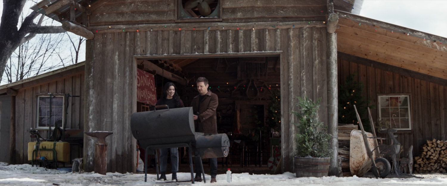 Clint and Kate outside the Barton farm barn with a barbecue.