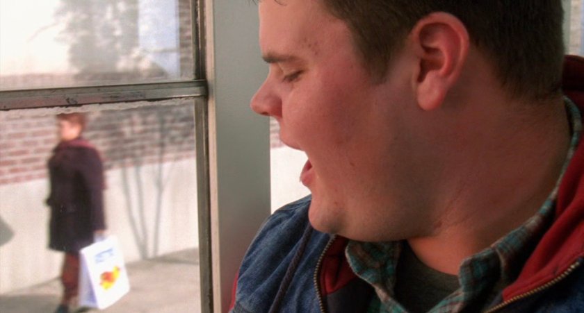 Student looking out window on school bus.
