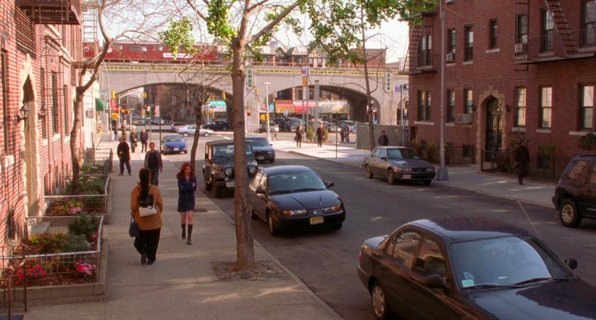 New York street with elevated track in background.