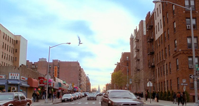 Peter Parker swinging across the street.