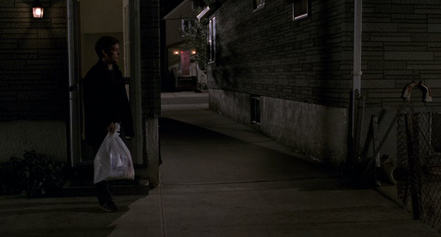 Back alley behind Peter Parker house at night.