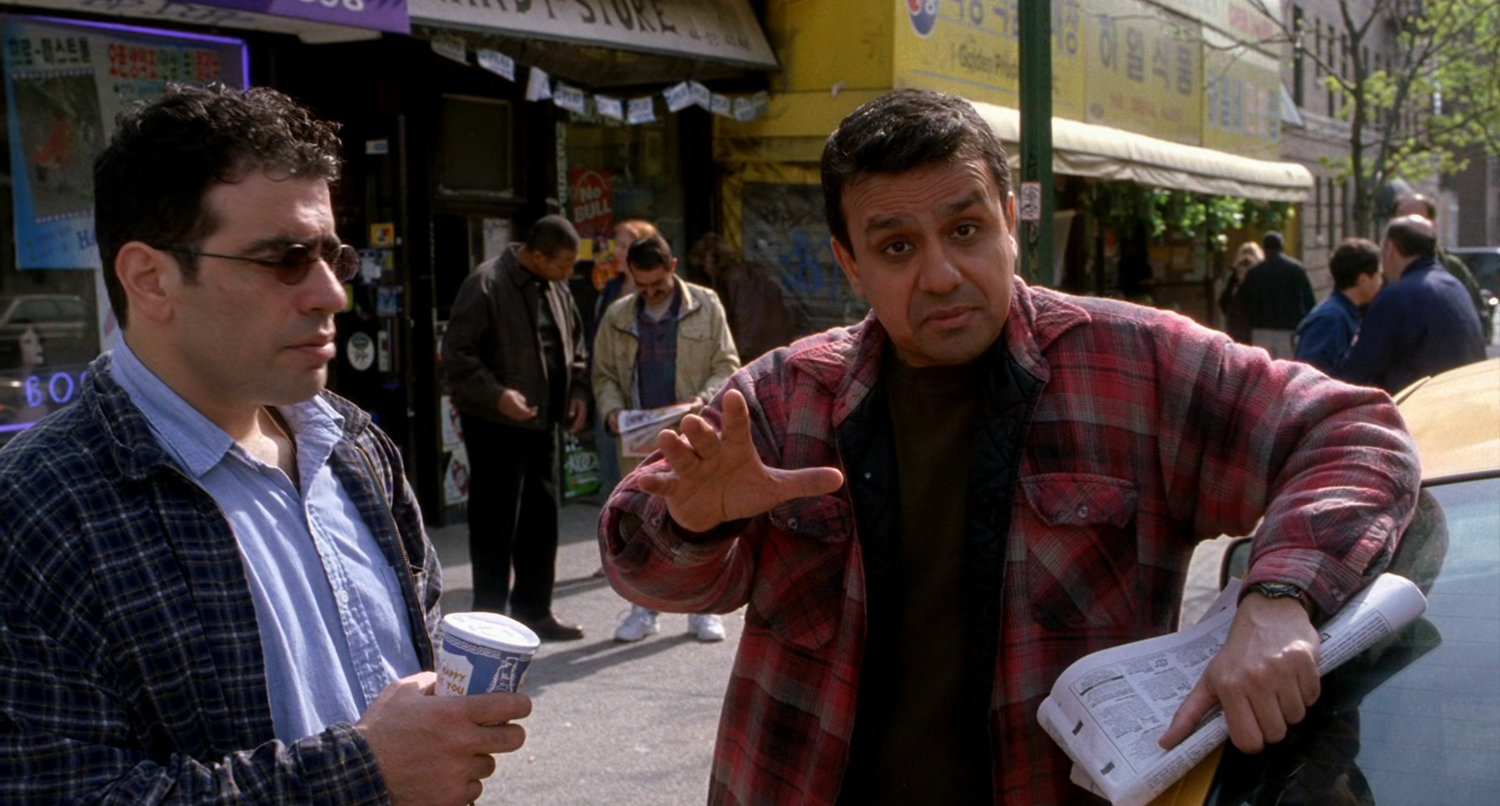 Two men on street being interviewed.