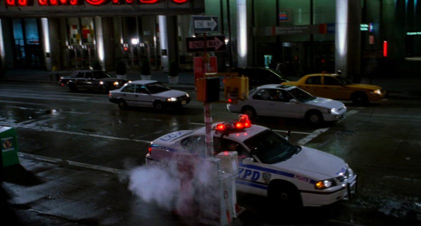 NYPD police car on street at night.