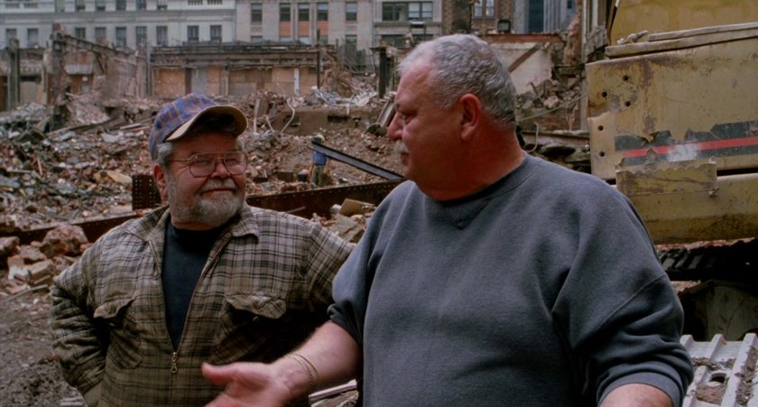 Two men at construction site being interviewed.
