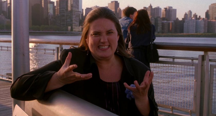 Woman at riverside pier being interviewed.