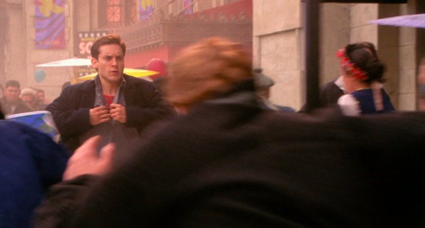 Peter Parker pulls his shirt open to reveal costume underneath.