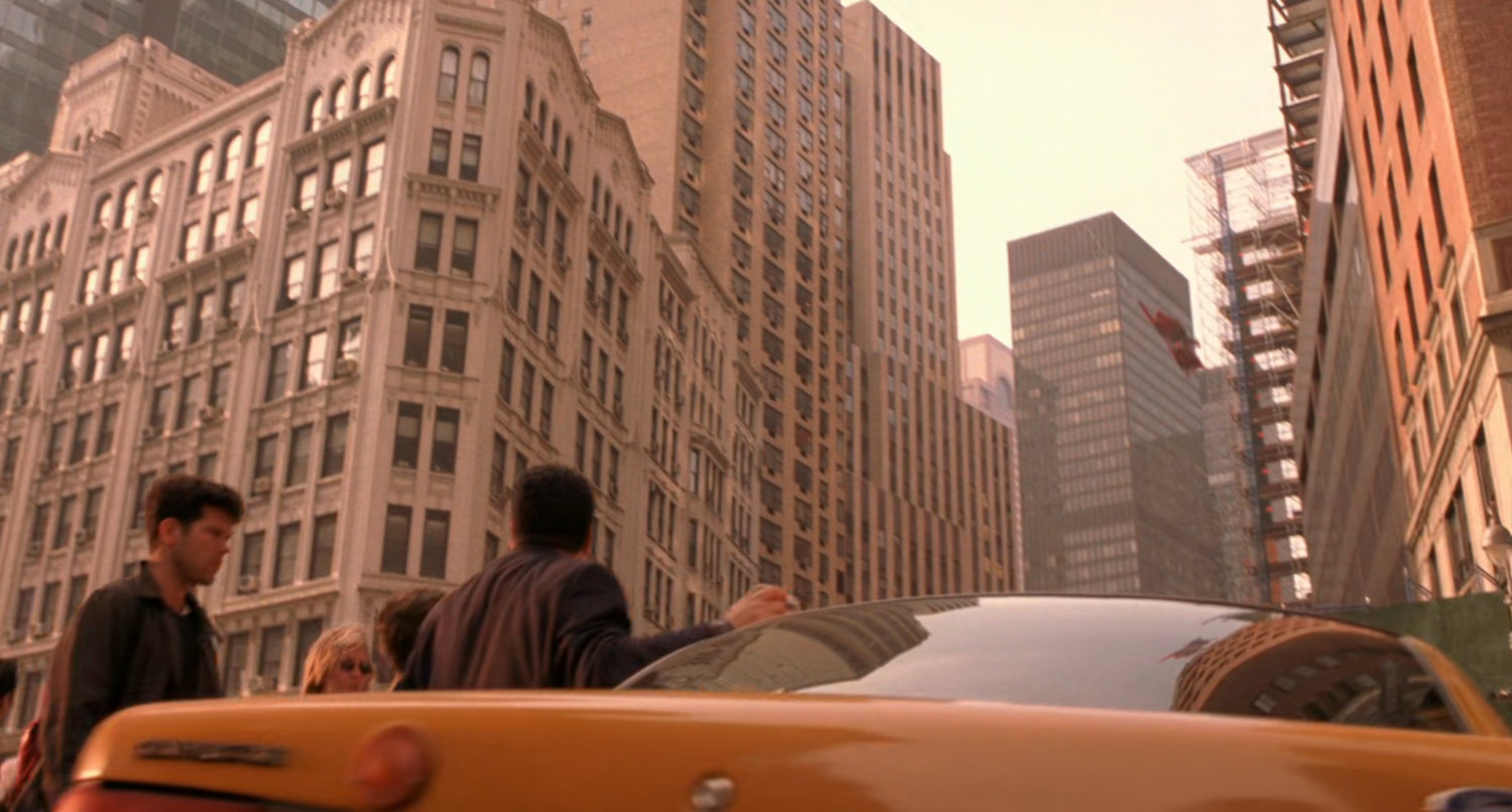 Spider-Man swings through New York intersection.