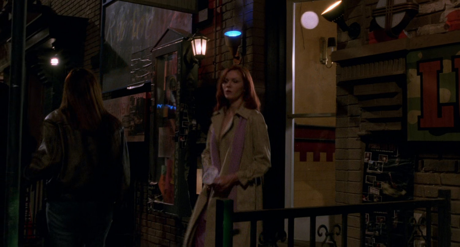 Mary Jane exits building at night.