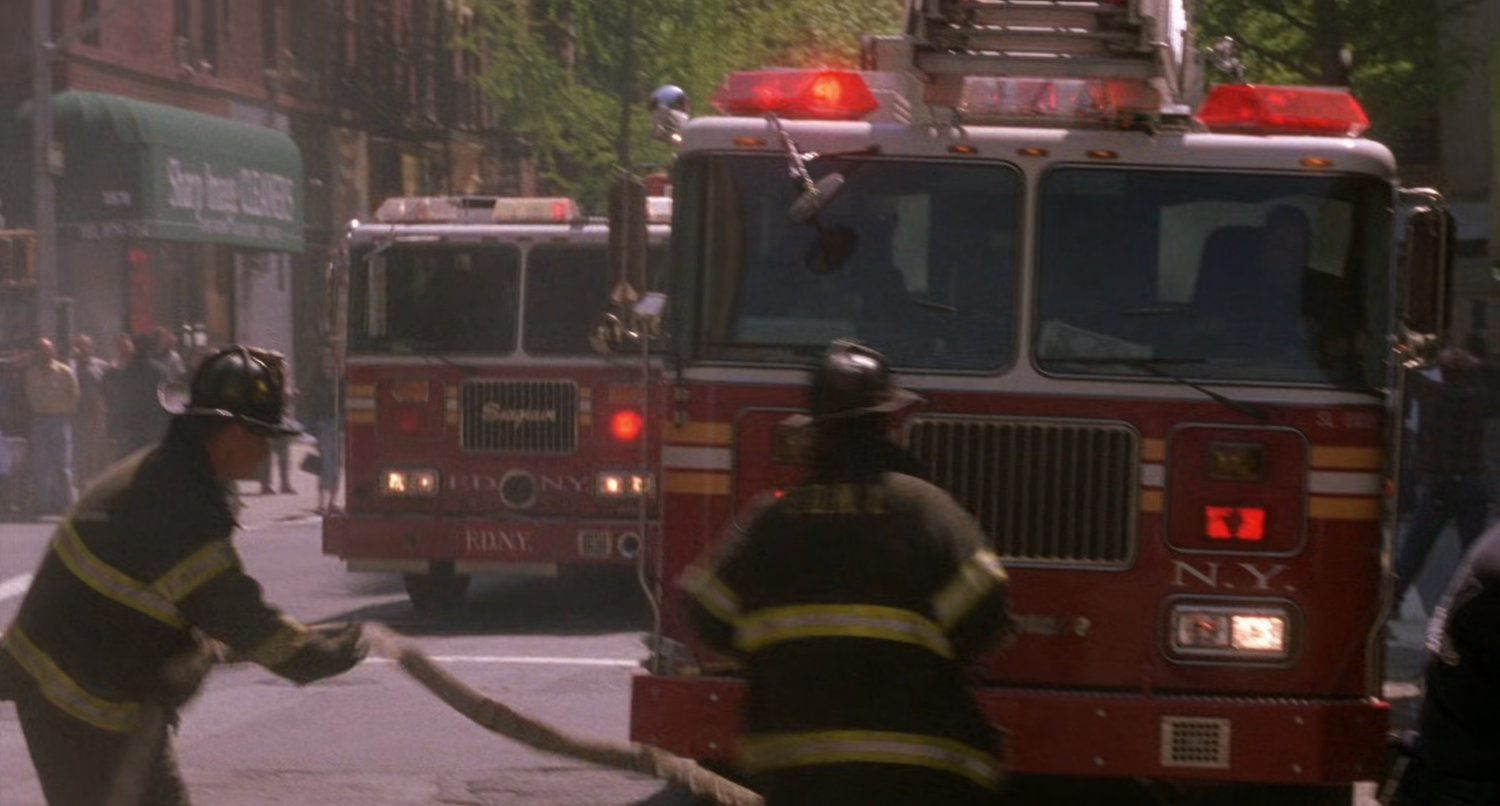 Fire engines pull up on New York street.