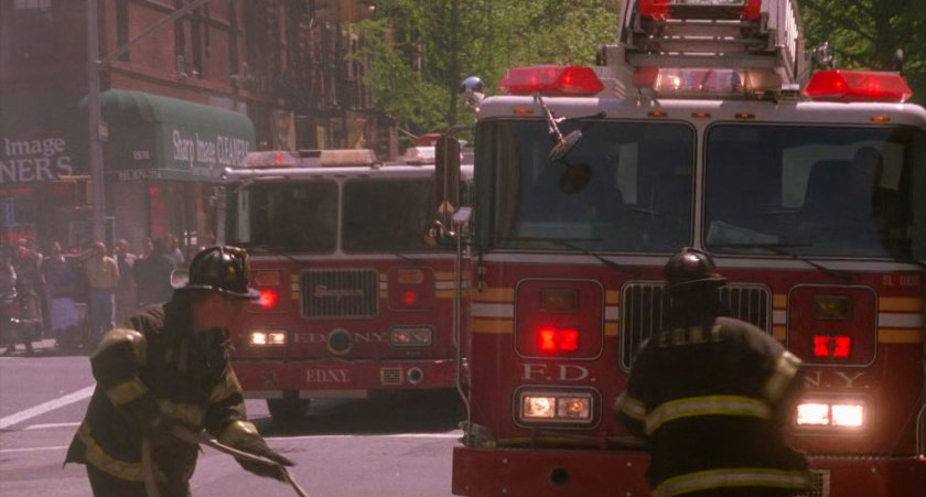 Fire engines pull up on New York street.